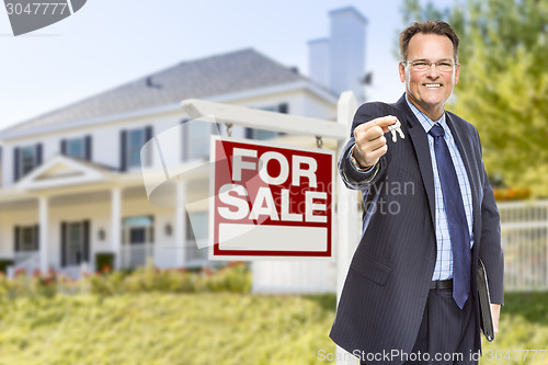 Image of Agent with Keys in Front of Sale Sign and House