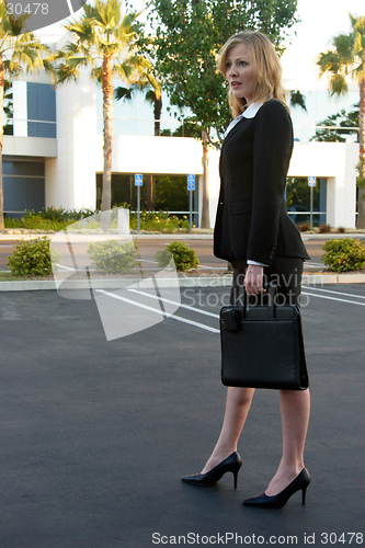 Image of Business woman standing in parking lot