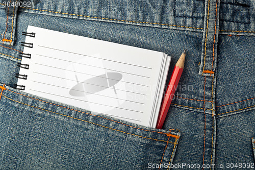 Image of Notepad and pencil in jeans pocket