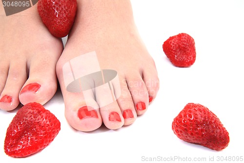 Image of women feet (pedicure) with  strawberries