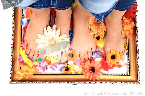 Image of women feet (pedicure)  with flowers