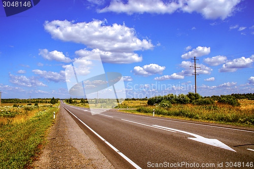 Image of Speedway road through natural landscape in summer