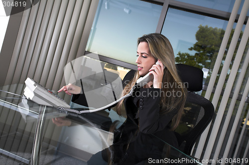 Image of sitting at her desk