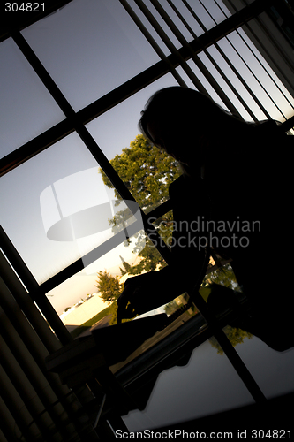 Image of sitting at her desk