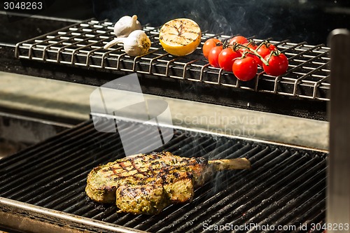 Image of steak flame broiled on a barbecue