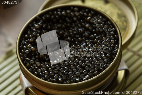 Image of Black caviar in small round metal tin 