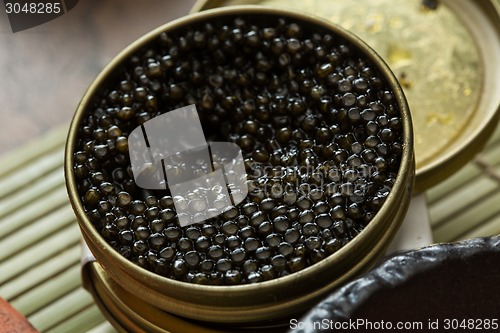 Image of Black caviar in small round metal tin 