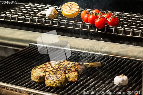 Image of steak flame broiled on a barbecue