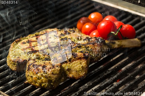 Image of steak flame broiled on a barbecue