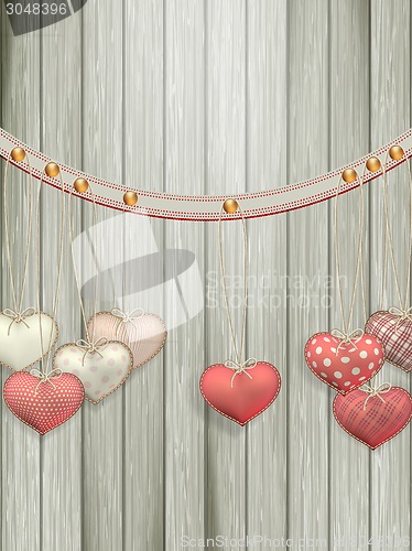 Image of Red hearts hanging over old wood. EPS 10
