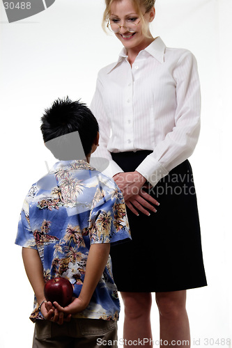 Image of Boy holding an Apple behind his back