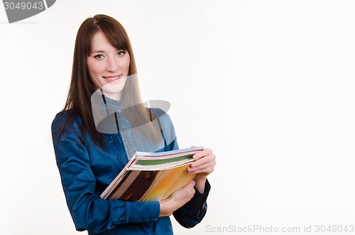 Image of Portrait of girl in office clothes and with magazines 