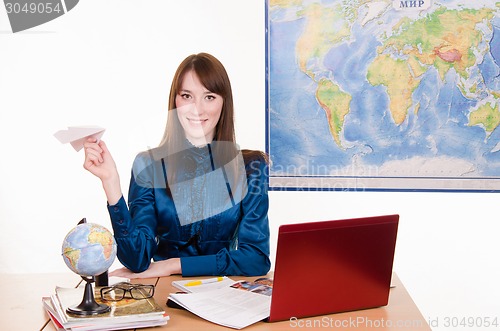 Image of Young employee travel company with an airplane in hand