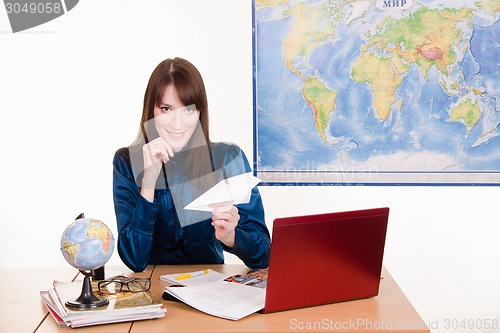 Image of employee travel company with an airplane in hand