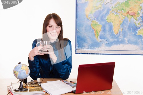 Image of manager of travel agency is drinking tea with customers