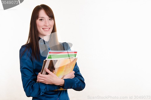 Image of Young girl holding a stack of magazines