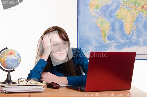 Image of Travel agency manager relaxed sitting at the table