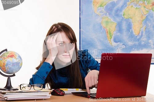 Image of Tired geography teacher at a laptop
