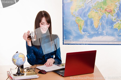 Image of Young employee with a mug of tea