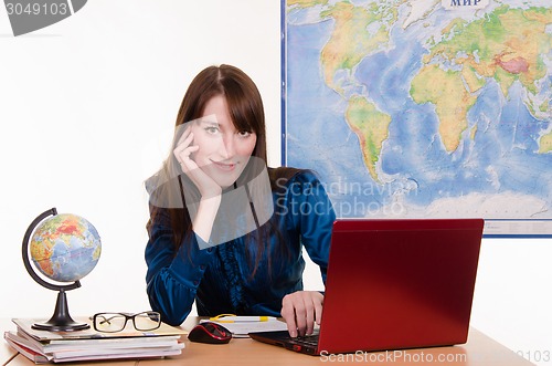 Image of Geography teacher working at a laptop