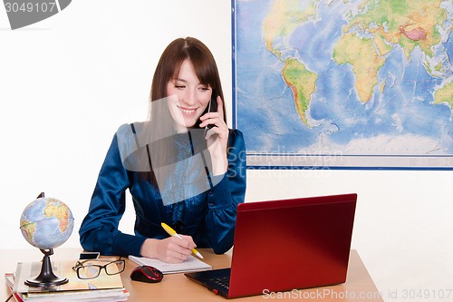 Image of Office manager travel agency on the phone