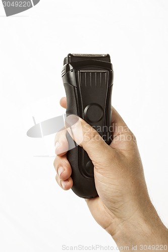 Image of beard clipper in hand