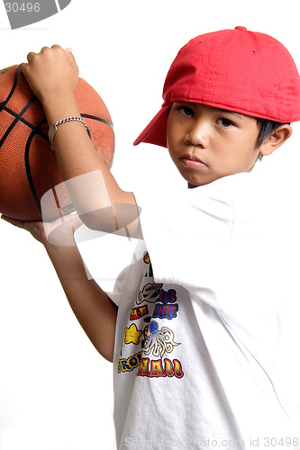 Image of Pensive boy holding a basketball