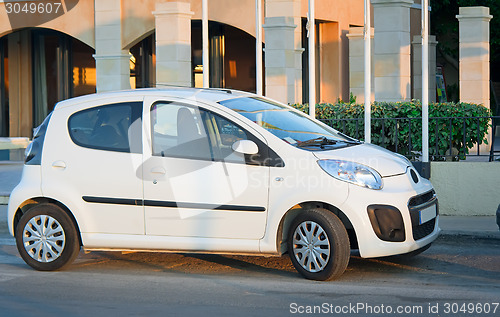 Image of A small car in the Parking lot near the hotel.