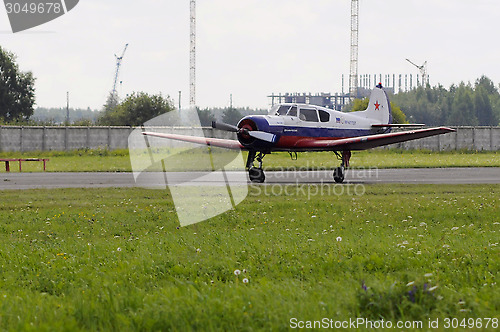 Image of The Yak-18t plane on a runway.