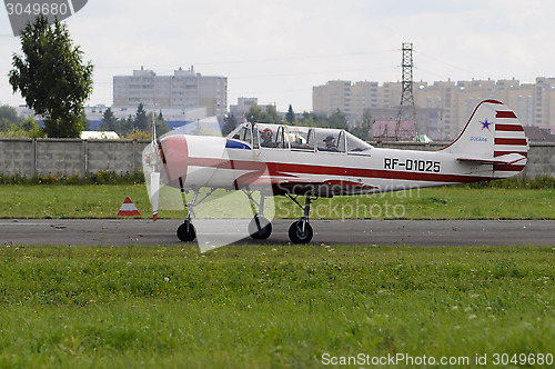 Image of The small white plane on a runway.