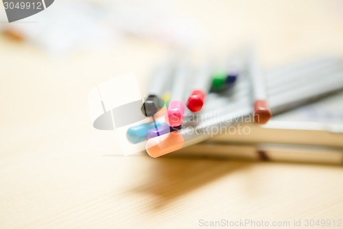 Image of Close up of color pencils with over wooden background