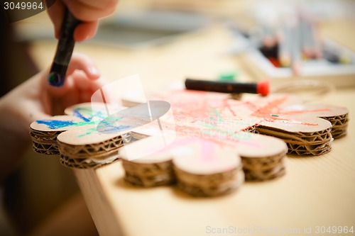 Image of Little female baby painting with colorful paints