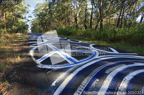 Image of Peace Odyssey - peace signs grafitti on the road painted Seal Ro