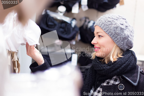 Image of Beautiful lady shopping in lingerie store.