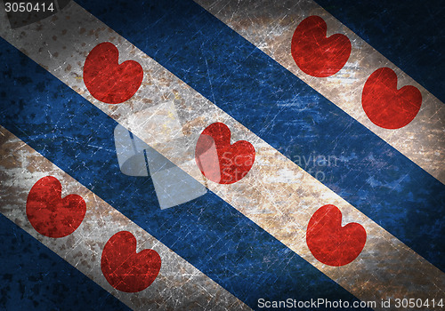 Image of Old rusty metal sign with a flag