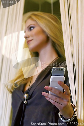 Image of businesswoman talking on mobile phone wmn