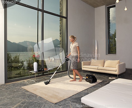 Image of housewife with vacuum cleaner