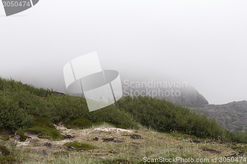 Image of air stream of fog through mountains. polar circle