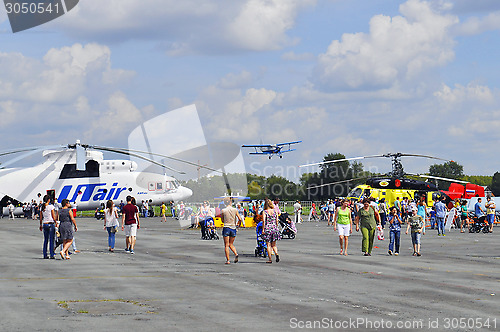 Image of Air show. Helicopters and the flying plane in the sky.