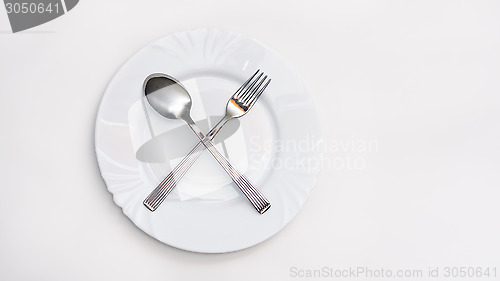 Image of Fork, spoon and white plate