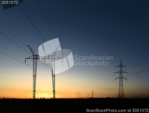 Image of Large transmission towers at sunset