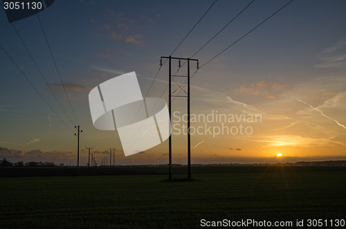 Image of Power lines rows at sunset