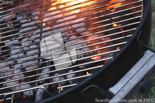 Image of bbq flames through the grid