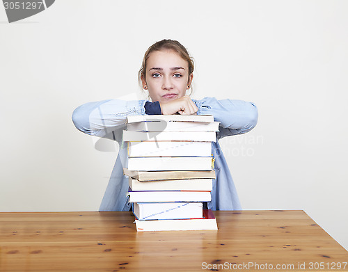 Image of Schoolgirl with pile of books