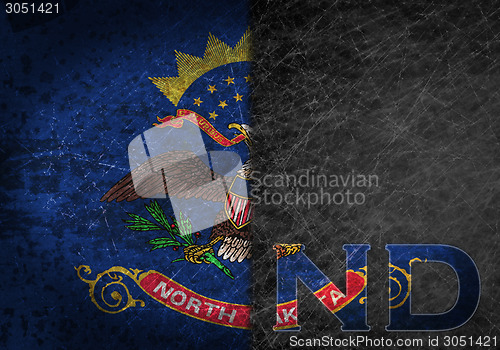 Image of Old rusty metal sign with a flag and US state abbreviation