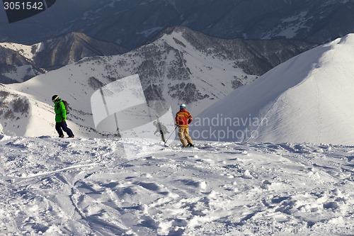 Image of Freeriders on off-piste slope in sun evening