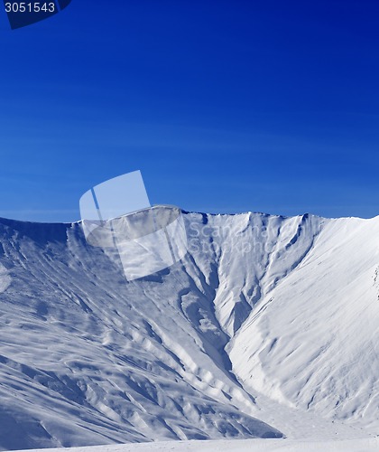 Image of Off-piste slope with traces of avalanche in sun morning