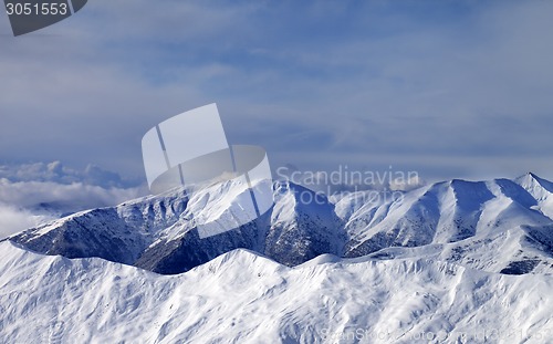 Image of Winter mountains in clouds at windy day