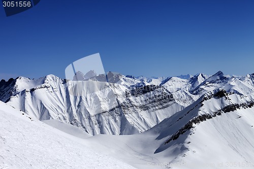 Image of Off-piste slope in sun day and traces of avalanches, ski and sno