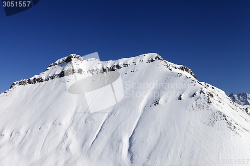 Image of Snowy rocks in sun day